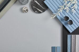 Flat lay composition of stylish architect moodboard with samples of textile, paint, blue wooden lamella panels and tiles. White, black, blue and light grey color palette. Copy space. Template. photo