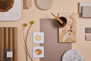 Flat lay of stylish architect moodboard composition with beige samples of textile, paint, wooden lamella panels and tiles. Top view. Copy space. Template. photo