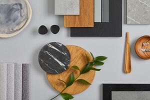 Elegant architect moodboard flat lay composition in light grey, black and brown color palette with textile and paint samples, wooden panels and marble tile. Top view. Copy space. Template. photo