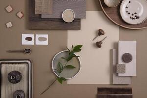 Flat lay of creative architect moodboard composition with samples of textile, paint, panels and tiles. Natural materials. Beige and brown color palette. Top view. Copy space. Template. photo