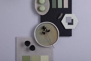 Stylish architect and interior designer moodboard. Flat lay composition in grey and green color palette with textile and paint samples, panels and tiles. Top view. Copy space. Template. photo