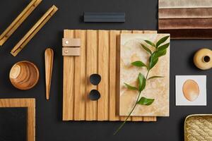 Creative architect moodboard. Flat lay composition in brown and black color palette with textile and paint samples, wooden lamella panels and tiles. Copy space. Template. photo