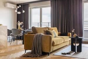 Creative and modern open space interior design with yellow sofa, grey carpet and coffe table . Grey carpet on the herringbone parquet with coffe table, brown curtain in windows. Template. photo