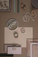 Creative flat lay composition of interior designer moodboard with textile and paint samples, panels and tiles. Beige, brown and green color palette. Copy space. Template. photo