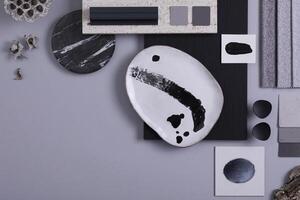 Creative flat lay composition in grey and black color palette with textile and paint samples, panels and tiles. Architect and interior designer moodboard. Top view. Copy space. Template. photo