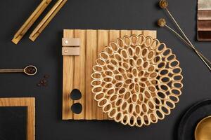 Stylish architect moodboard. Flat lay composition in golden, brown and black color palette with textile and paint samples, wooden lamella panels and tiles. Copy space. Template. photo