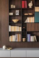 Modern bookcase in lamells wall. Grey chest of drawers. Bookcase a lot of books and accessories. Herringbone wooden parquet. Cat in open spaces. photo
