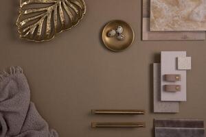 Creative flat lay composition with textile and paint samples, panels and tiles. Stylish interior designer moodboard. Golden and dark beige color palette. Copy space. Template. photo