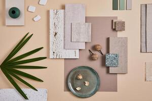 Creative flat lay composition of interior designer moodboard with textile and paint samples, panels and cement tiles. Beige, grey and green color palette. Copy space. Template. photo