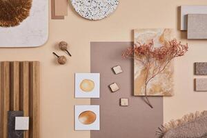 Flat lay of stylish architect moodboard composition with beige samples of textile, paint, wooden lamella panels and tiles. Top view. Copy space. Template. photo