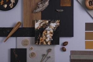 Creative architect moodboard flat lay composition in grey, black and brown color palette with textile and paint samples, wooden panels and marble tile. Top view. Copy space. Template. photo