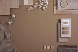 Flat lay of creative architect moodboard composition with samples of textile, paint, panels and tiles. Natural materials. Beige and brown color palette. Top view. Copy space. Template. photo