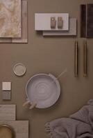 Creative flat lay composition of interior designer moodboard with textile and paint samples, panels and tiles. Beige, brown and grey color palette. Copy space. Template. photo