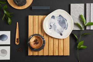 Creative flat lay composition with textile and paint samples, lamella panel and tiles. Stylish interior designer moodboard. Green, black and grey color palette. Copy space. Template. photo