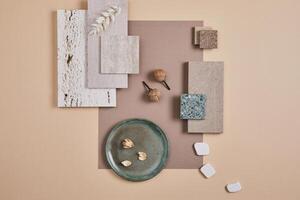 Creative flat lay composition of interior designer moodboard with textile and paint samples, panels and cement tiles. Beige, grey and green color palette. Copy space. Template. photo