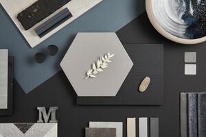 Flat lay of stylish architect moodboard composition with black, beige and grey samples of textile, paint, panels and tiles. Top view. Copy space. Template. photo