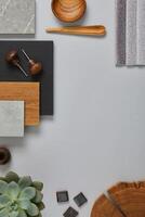 Perfect architect moodboard. Flat lay composition in light grey, black and brown color palette with textile and paint samples, wooden panels and tiles. Top view. Copy space. Template. photo