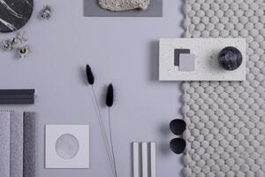 Stylish architect and interior designer moodboard. Flat lay composition in grey color palette with textile and paint samples, panels and tiles. Top view. Copy space. Template. photo
