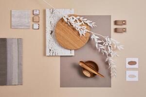 Creative flat lay composition with textile and paint samples, panels and cement tiles. Stylish interior designer moodboard. Light beige color palette. Copy space. Template. photo