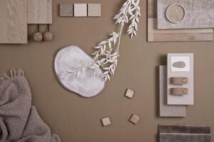 Creative flat lay composition of interior designer moodboard with textile and paint samples, panels and tiles. Beige, brown and grey color palette. Copy space. Template. photo