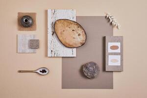 Creative flat lay composition with textile and paint samples, panels and cement tiles. Stylish interior designer moodboard. Light beige color palette. Copy space. Template. photo