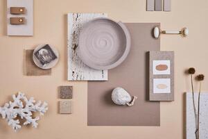 Creative interior designer moodboard. Flat lay composition with textile and paint samples, panels and cement tiles. Beige and grey color palette. Copy space. Template. photo