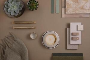 Creative flat lay composition of interior designer moodboard with textile and paint samples, panels and tiles. Beige, brown and green color palette. Copy space. Template. photo