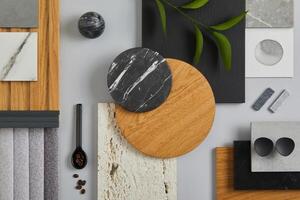 Elegant architect moodboard flat lay composition in light grey, black and brown color palette with textile and paint samples, wooden panels and marble tile. Top view. Copy space. Template. photo