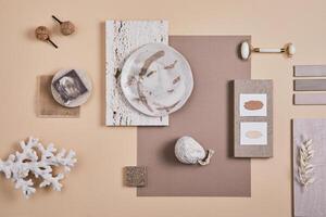 Creative interior designer moodboard. Flat lay composition with textile and paint samples, panels and cement tiles. Beige and grey color palette. Copy space. Template. photo