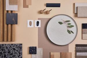 Creative flat lay composition of interior designer and architect moodboard. Textile and paint samples, lamella panels and lastrico tiles. Beige, black and green color palette. Copy space. Template. photo