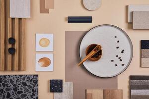 Flat lay of stylish architect moodboard composition with beige samples of textile, paint, wooden lamella panels and tiles. Top view. Copy space. Template. photo