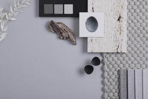 Stylish architect and interior designer moodboard. Flat lay composition in grey color palette with textile and paint samples, panels and tiles. Top view. Copy space. Template. photo