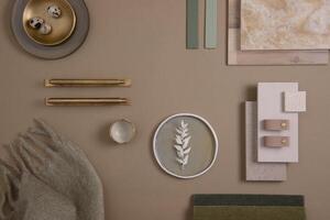 Creative flat lay composition of interior designer moodboard with textile and paint samples, panels and tiles. Beige, brown and green color palette. Copy space. Template. photo