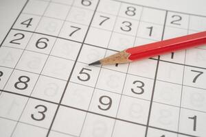 Sudoku puzzle game playing to challenge brain. photo