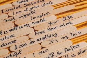 Positive thoughts for increasing selfesteem on wooden posts on wooden background photo