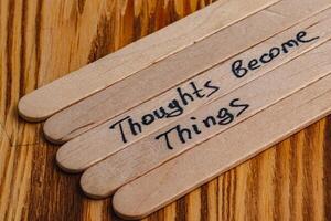 Positive thoughts for increasing selfesteem on wooden posts on wooden background photo