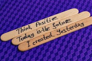 Positive thoughts for increasing self-esteem on wooden posts on blue background photo