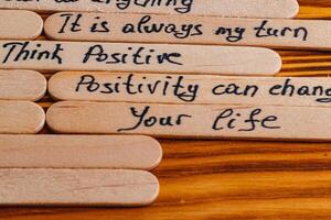 Positive thoughts for increasing selfesteem on wooden posts on wooden background photo
