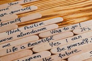 Positive thoughts for increasing selfesteem on wooden posts on wooden background photo