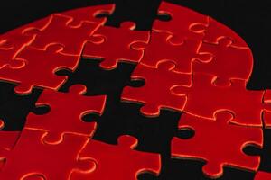 Feelings concept. missing pieces in puzzle, broken love on black background photo