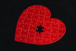 Concept of unrequited feelings, heart puzzle with missing element photo