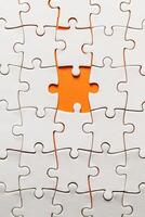 Conceptual photo of a puzzle, missing piece, on an orange background