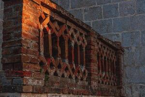 Krk Croatia 28.06.24Old restored brick fence near the church photo