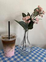 Refreshing iced coffee and floral arrangement cozy cafe still life bright atmosphere close-up calm vibes photo