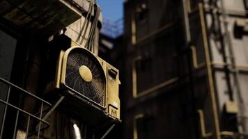 Old air conditioning unit mounted on a weathered building in an urban area video