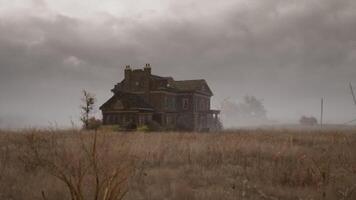 Old abandoned house in a desolate field under a gloomy sky video