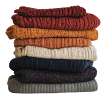 Cozy sweaters stacked in warm autumn colors png