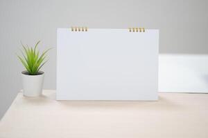Blank desk calendar on table in mock up and copy space concept. photo