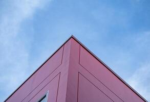 Colorful red building architecture and blue sky, bright sunlight, abstract background photo