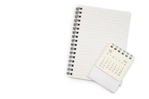 December 2024, Monthly desk calendar for 2024 year with note book isolated on white background. photo